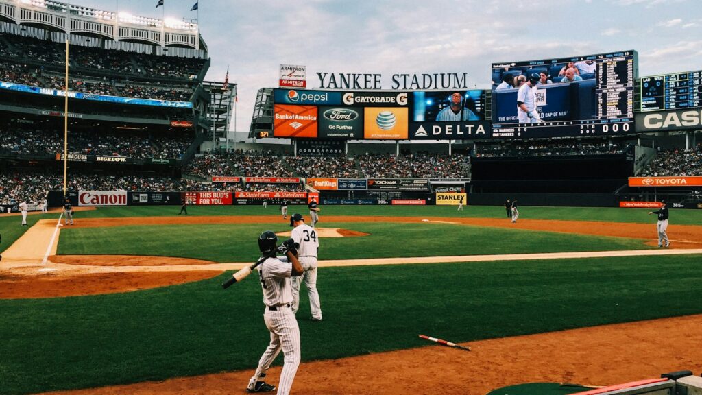 baseball players playing on field during daytime