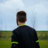 a man standing in a field with a frisbee in his hand