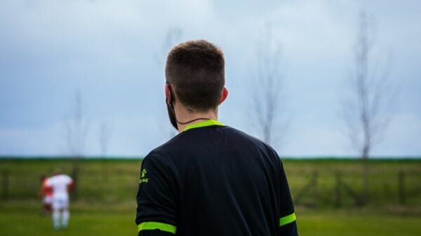 a man standing in a field with a frisbee in his hand