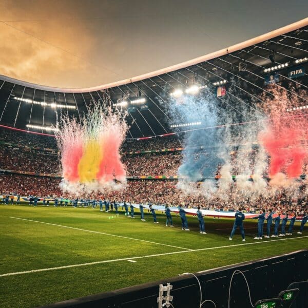A stadium filled with lots of people watching a soccer game