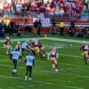 A football game is being played in a stadium