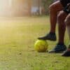 man in black shorts and black nike soccer ball on green grass field during daytime