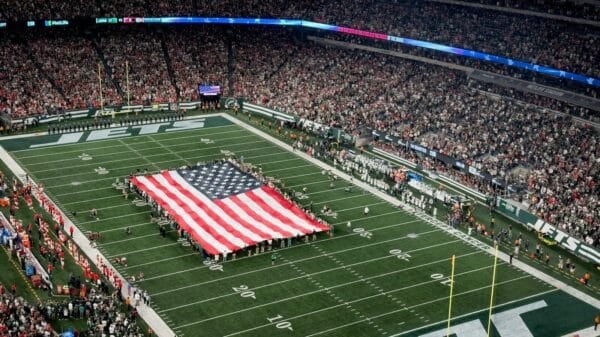 a football field with a large american flag on it