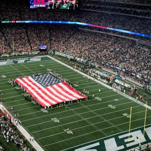 a football field with a large american flag on it