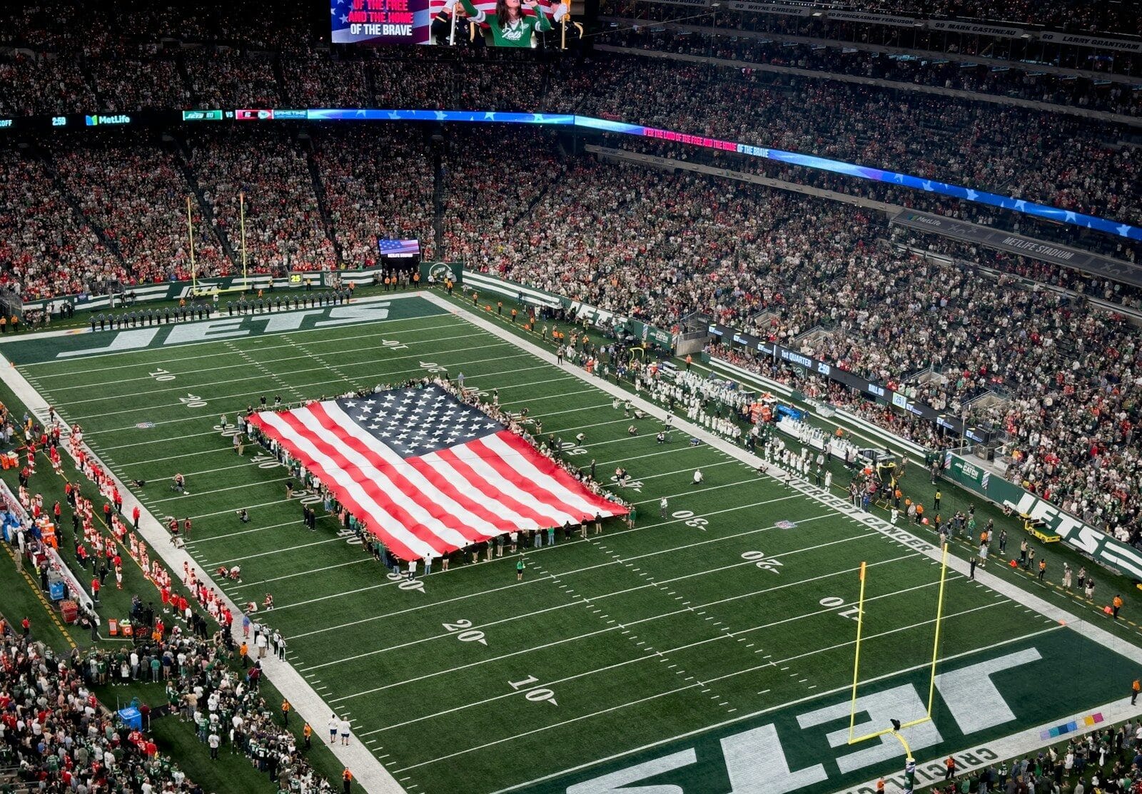a football field with a large american flag on it